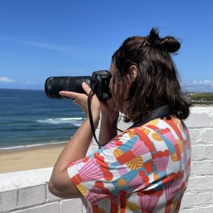 woman photographing ocean